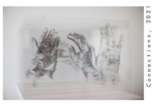 Print installation by Joe Lyttle showing parents' hands.